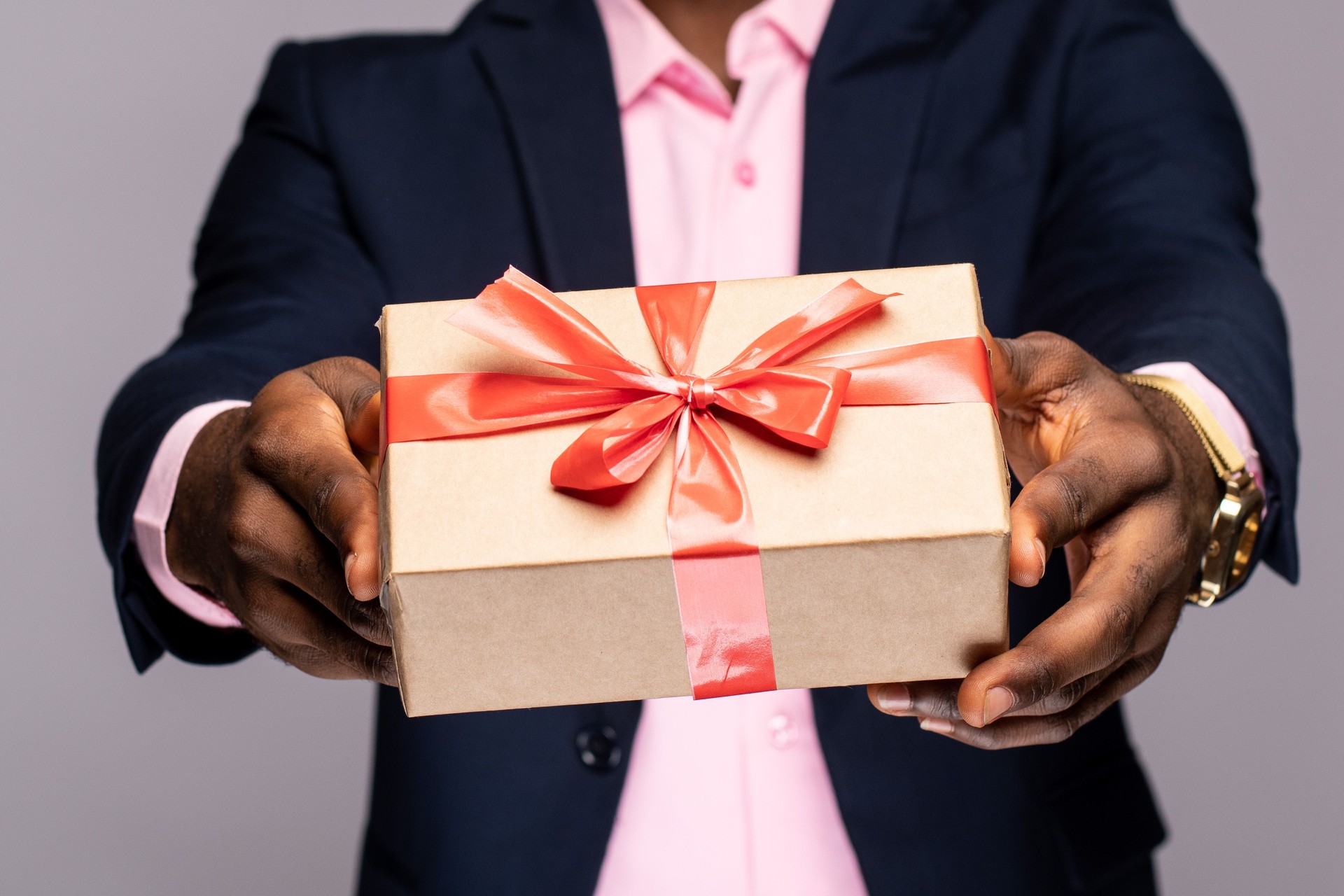 African American male holding a present